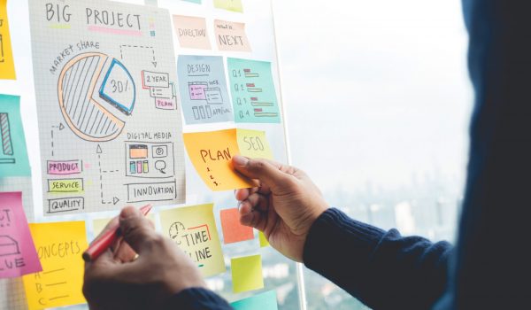 Sharing ideas concepts with papernote writing strategy on wall glass office.Business marketing Sharing ideas concepts with papernote writing strategy on wall glass office.Business marketing and communication